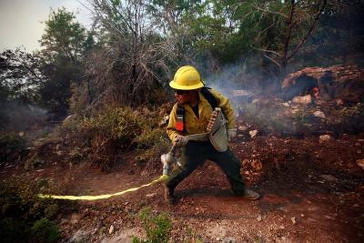 Tom Pennington/Getty Images News/Getty Images Prescribed fires can lower the fuel load, leading to smaller wildfires.