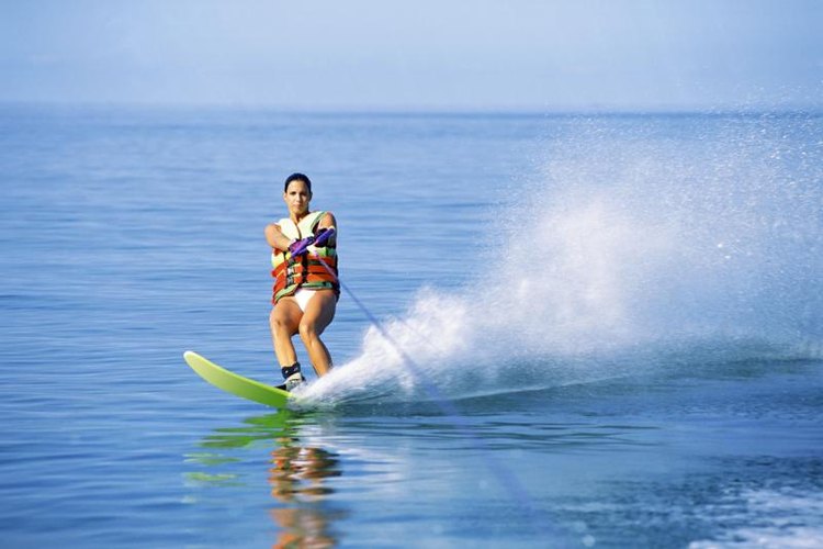 Thinkstock/Stockbyte/Getty Images A woman slaloms while hanging onto a waterski rope.