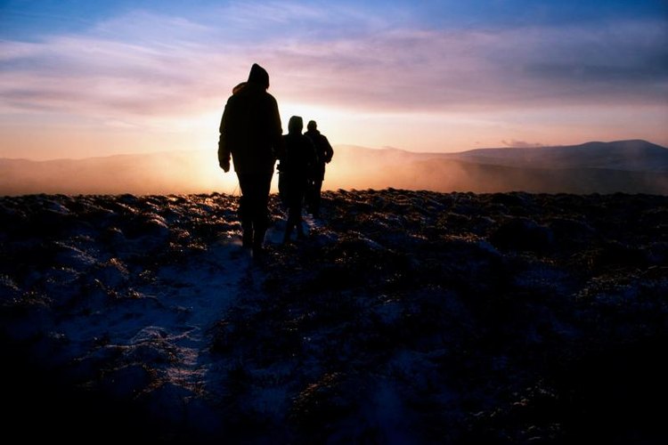 Design Pics/Design Pics/Getty Images People hiking at night in Ireland.