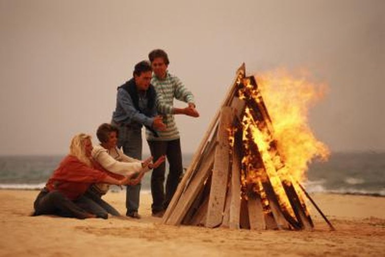 David De Lossy/Photodisc/Getty Images Wind helps supply oxygen to the fire, but too much wind reduces the fire's temperature.