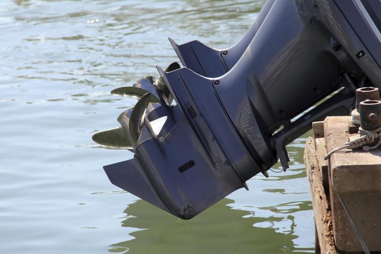 flik47/iStock/Getty Images Outboard engine of boat above water.