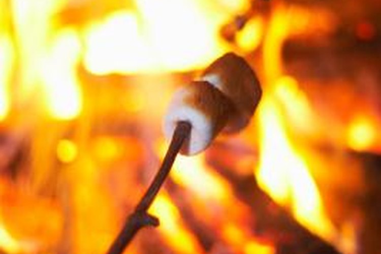 Jupiterimages/Photos.com/Getty Images Seal the ends of logs used for seating around a campfire with polyurethane.