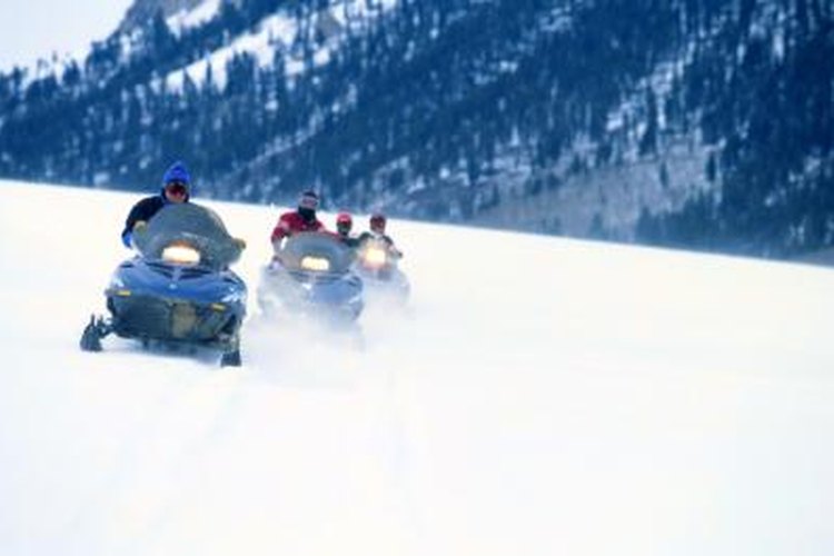Steve Mason/Photodisc/Getty Images Friends using Ski-Doos on a snow covered mountain.