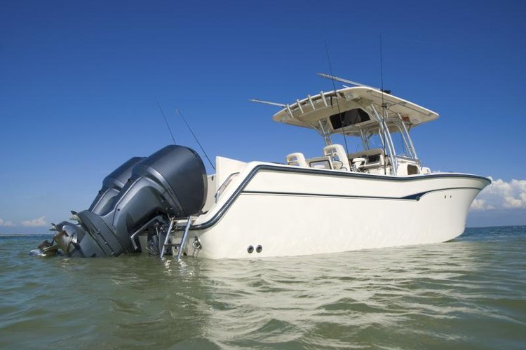 smlharvey/iStock/Getty Images Large outboard motors on back of boat in water.