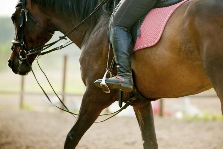 mari_art/iStock/Getty Images A girl is riding a horse.