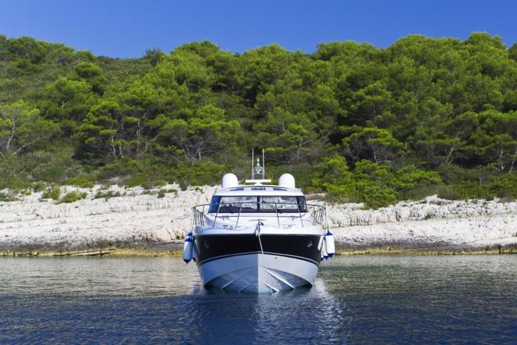 gaspr13/iStock/Getty Images An anchored speedboat in shallow water.