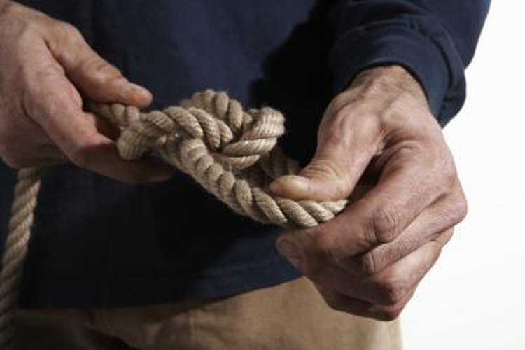 Thomas Northcut/Stockbyte/Getty Images Loosen a tight knot with effort.