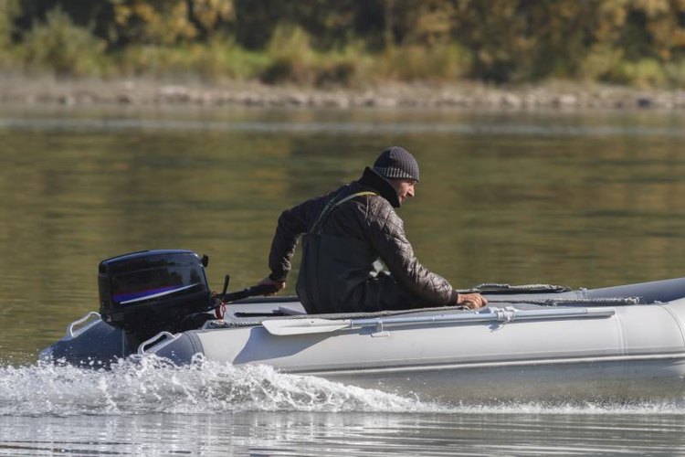 Ohotnik/iStock/Getty Images Man steering his motor boat on a lake.