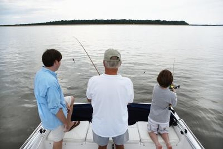 Thomas Northcut/Photodisc/Getty Images Family fishing off of dock.