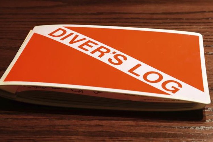 Endurodog/iStock/Getty Images A red and white diver's log on a wooden table.