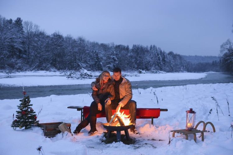 altrendo images/Stockbyte/Getty Images Couple sitting in front of a campfire.