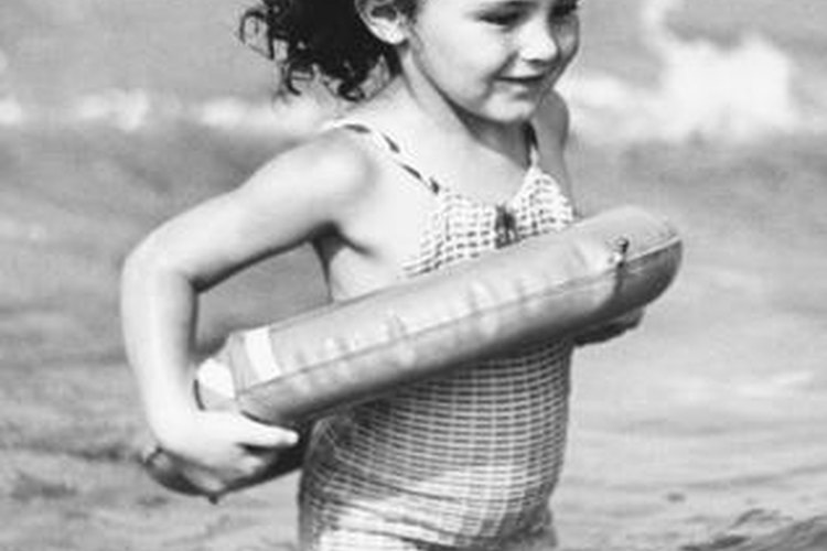 George Marks/Retrofile/Getty Images Swimming tubes give timid children more confidence in the water.