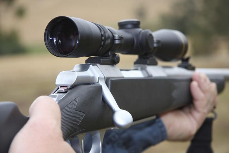 Martin Auldist/iStock/Getty Images The scope on top of a hunting rifle.