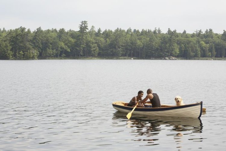 LWA/Larry Williams/Blend Images/Getty Images Couple canoeing in middle of lake.