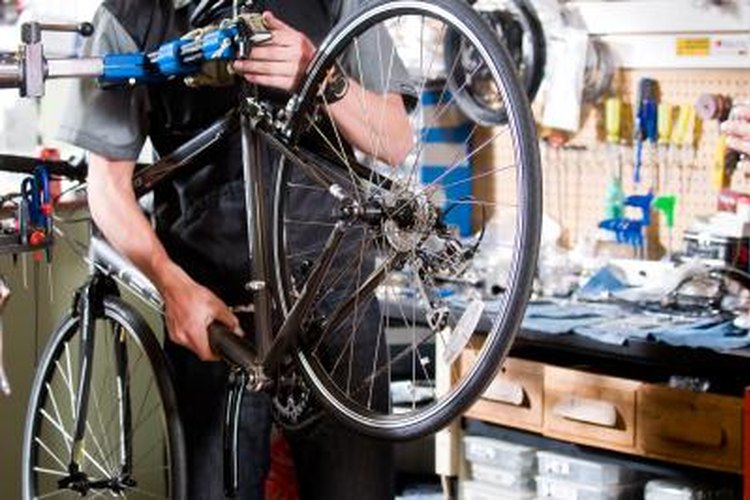 Jupiterimages/Photos.com/Getty Images Build a solid bike stand with a steel rim from a car.