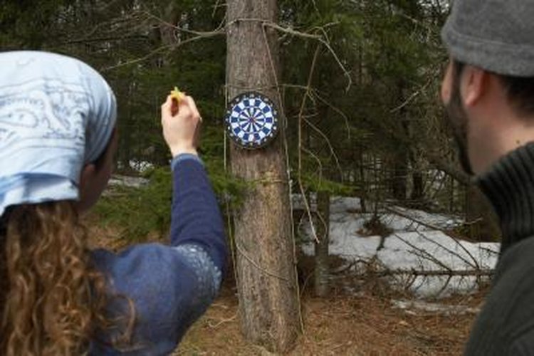 Michael Turek/Photodisc/Getty Images A young couple is playing a game of darts.