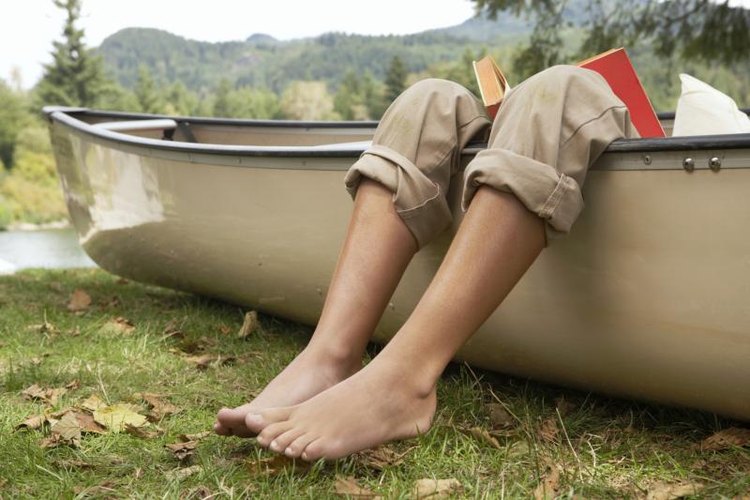 Noel Hendrickson/Digital Vision/Getty Images Feet hanging out of a canoe.