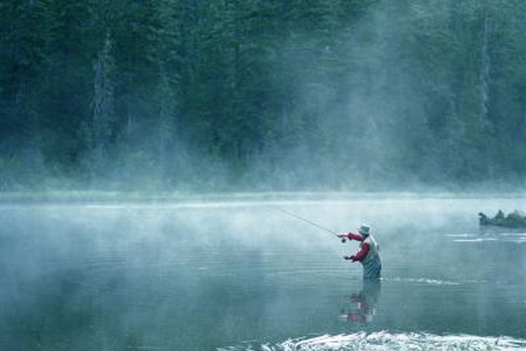 Mike Powell/Digital Vision/Getty Images Man fishing on a small lake.