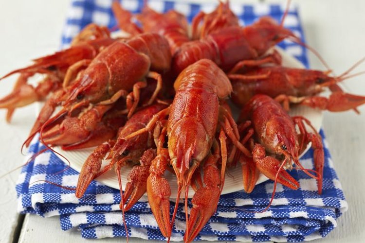 irrez79/iStock/Getty Images Cooked crawfish on a blue napkin.
