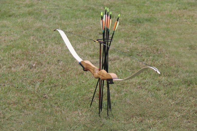 daseaford/iStock/Getty Images Longbow and bow set on grass.