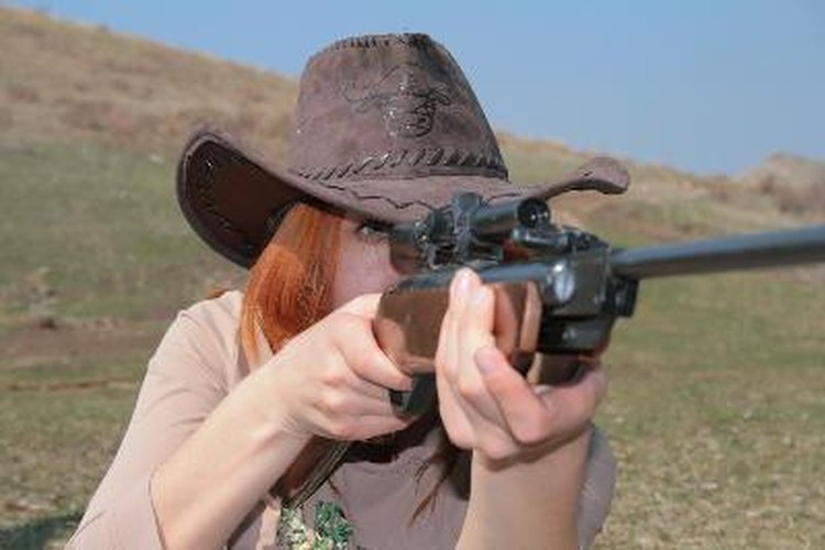 The Woman with rifle image by ssg from Fotolia.com