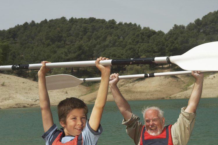 Maria Teijeiro/Digital Vision/Getty Images Helping each other meet a physical goal -- such as completing a canoe trip -- is an excellent challenge for family and friends.