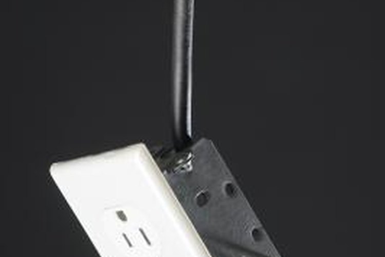 Hemera Technologies/AbleStock.com/Getty Images Outlets with three slots incorporate a third wire for earth ground.