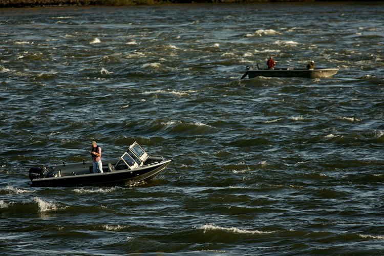 Craig Mitchelldyer/Getty Images News/Getty Images Men fish from boats on choppy Columbia River