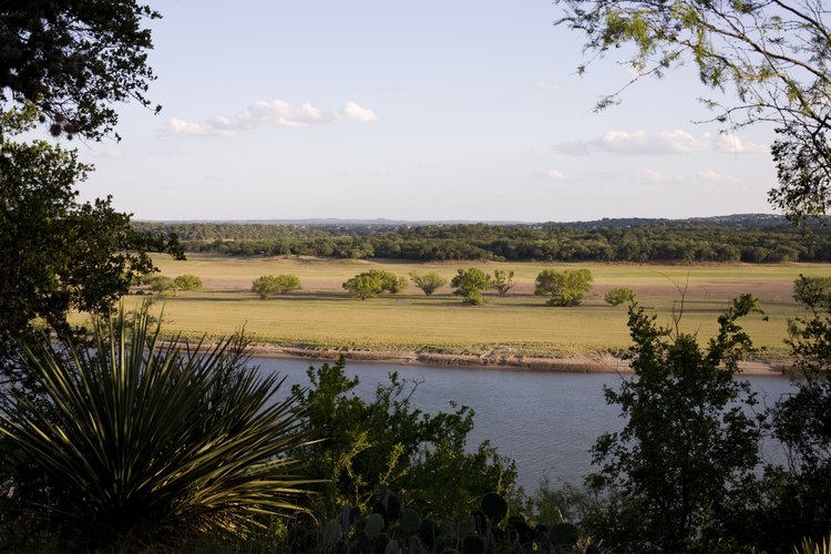 Jamie Kovach/iStock/Getty Images Looking at lake through trees in Austin, TX.