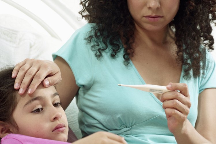 Usa un termómetro digital para medir la temperatura de un niño.