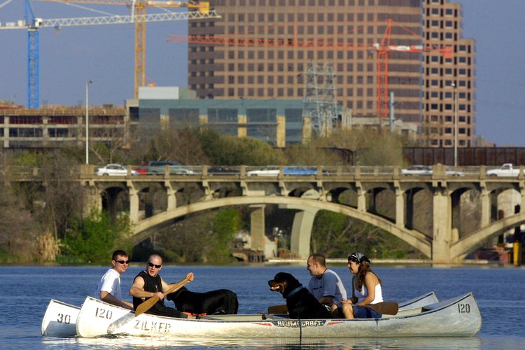 Joe Raedle/Hulton Archive/Getty Images Friends in canoes with dogs paddle on Town Lake (Lady Bird Lake)