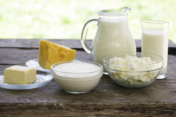 Varios alimentos lácteos sobre una mesa de campo.