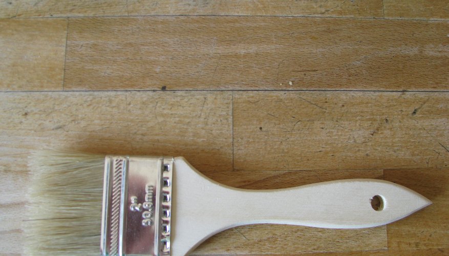 A paint brush can be used to cover wood stain.