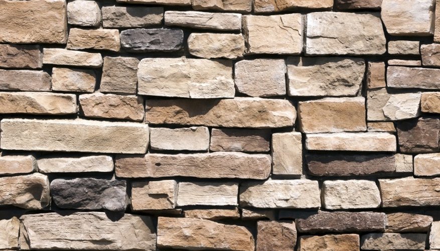 Water is the best cleaner for stone walls.