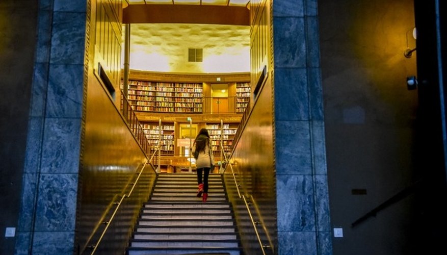 Woman in white shirt walking on gray concrete staircase.jpg