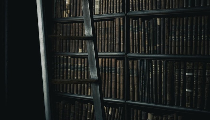 Black wooden ladder beside brown wooden bookshelf.jpg