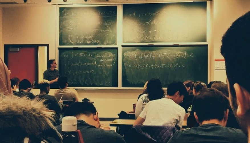 Student sitting on chairs in front of chalkboard.jpg