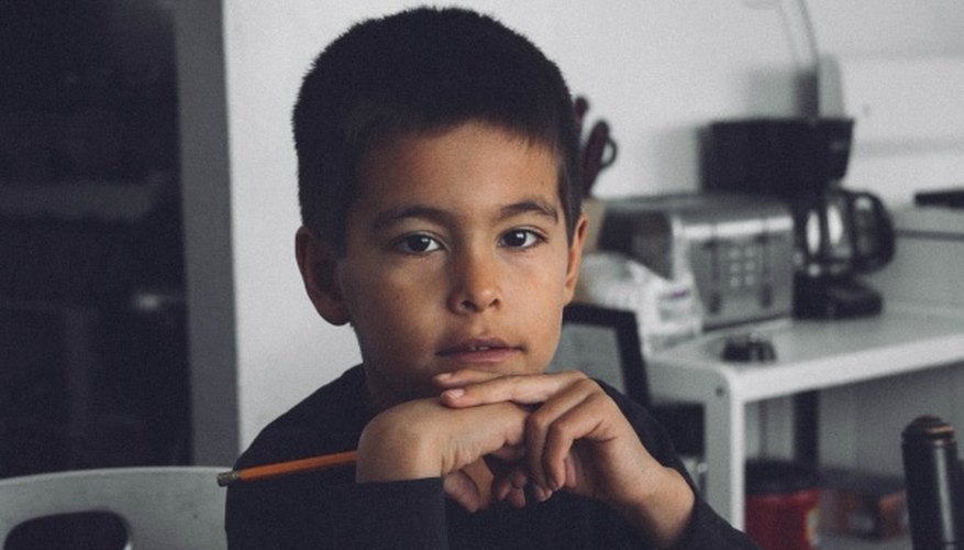Boy with black long-sleeved shirt holding pencil inside room.jpg