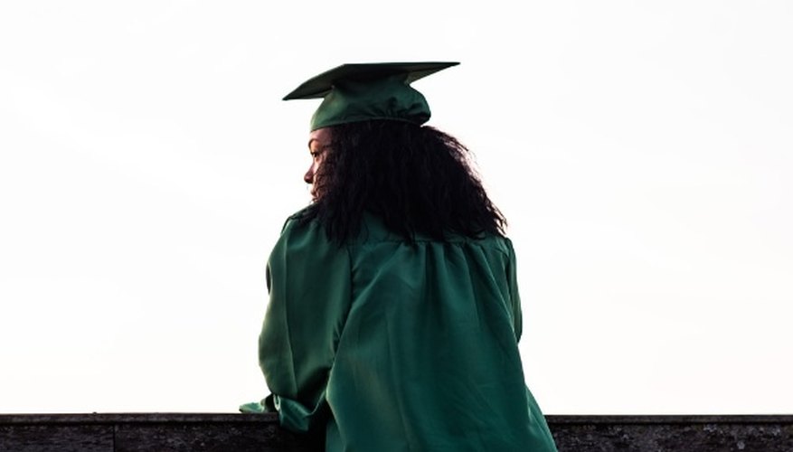 Woman standing at front of concrete fence wearing academic uniform.jpg