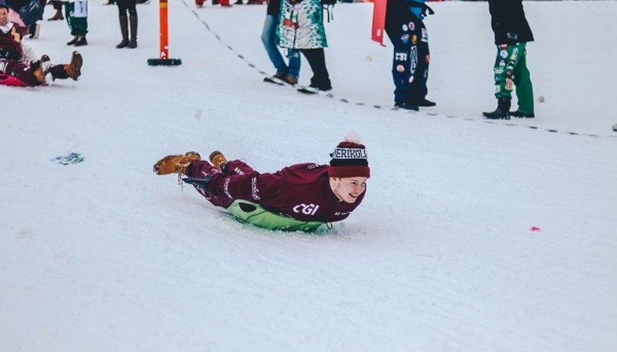 Person riding green board on downhill during snowtime.jpg