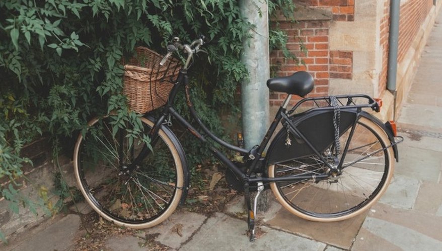 Parked black commuter bike near building.jpg
