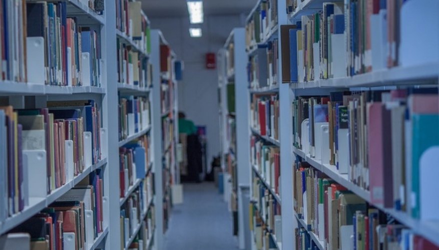 Assorted books on shelf inside building.jpg