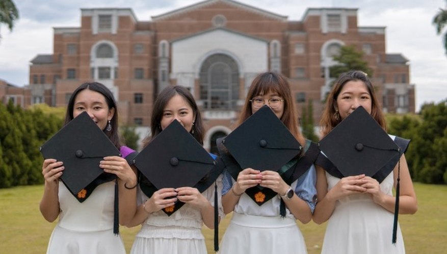 Four women holding caps.jpg