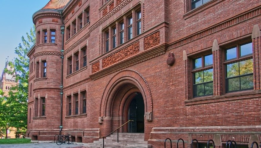 Brown brick building with white wooden fence.jpg
