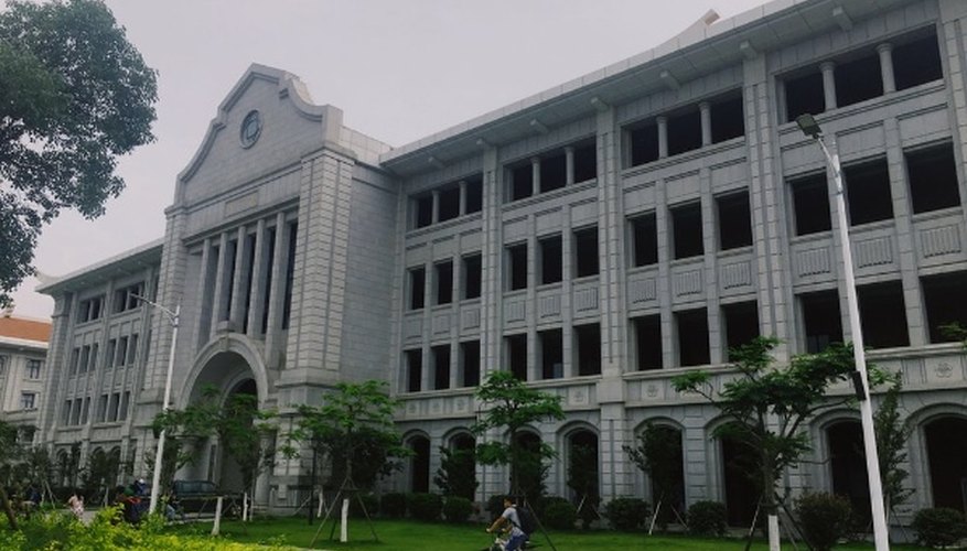 Gray concrete building near green grass field during daytime.jpg