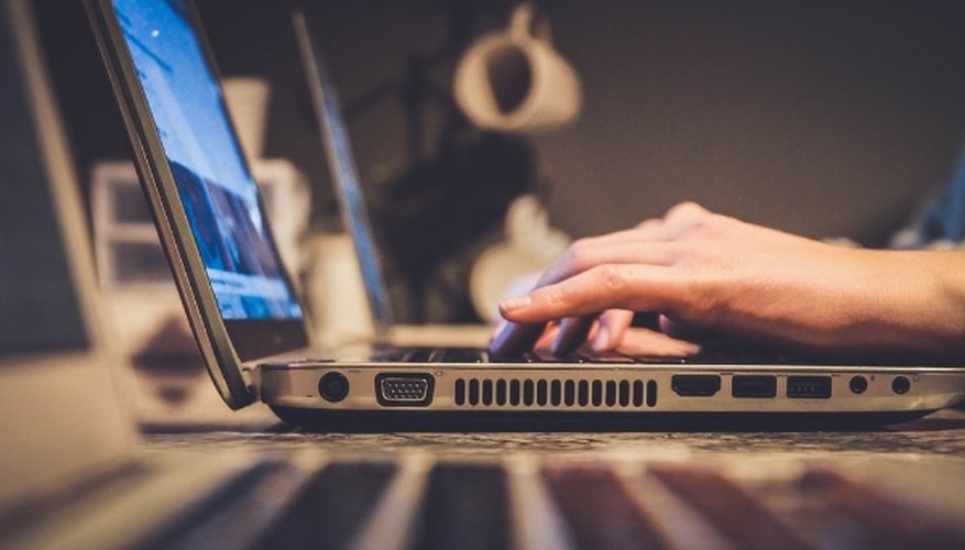 Person using silver laptop computer on desk.jpg