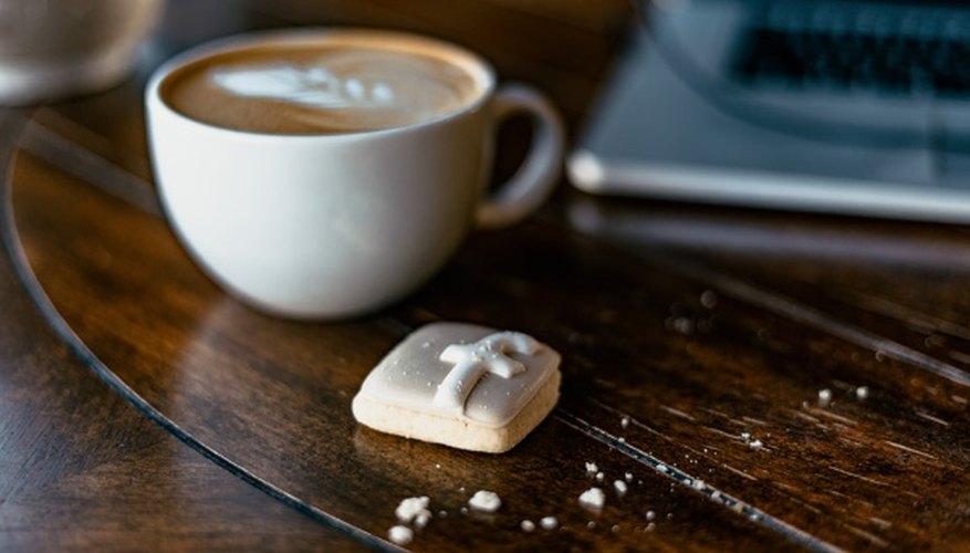White ceramic teacup beside the laptop.jpg