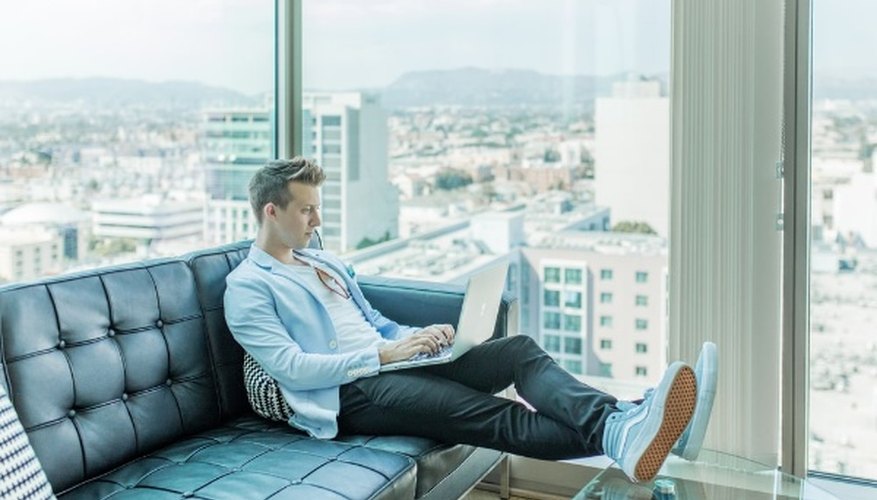 Man sitting on sofa while using laptop.jpg