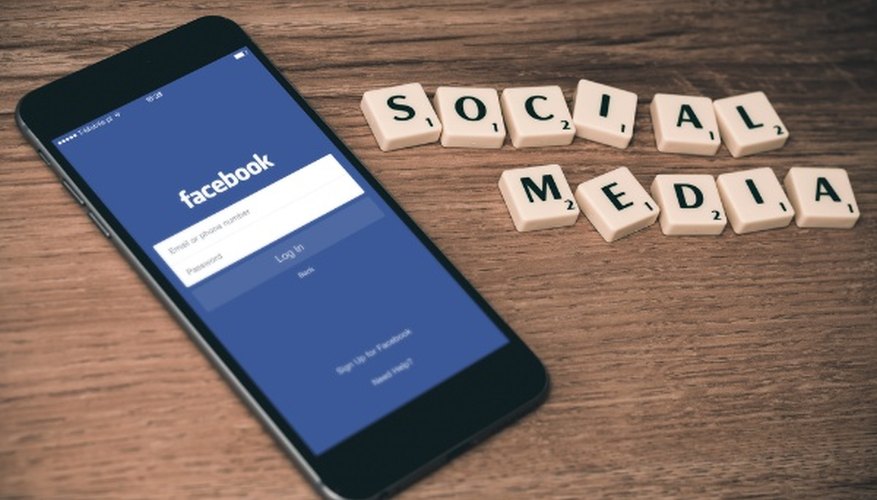 Space gray iphone 6 with facebook log-in display near social media scrabble tiles.jpg