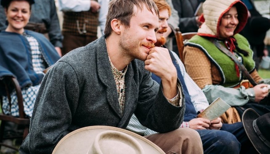 Man wearing black coat sitting beside man in blue vest during daytime.jpg